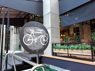 The white bicycle park sign in front of coffee shop in Thailand