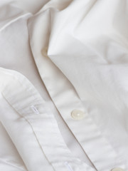 Plastic button on a white shirt