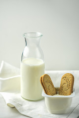 oatmeal cookies and milk on a old wooden background