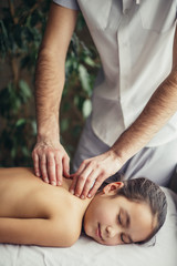 Obraz na płótnie Canvas Masseur doing massage back a little kid