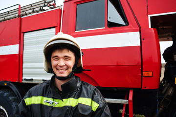 Fototapeta premium Portrait of a man, a firefighter, an Asian-Kazakh at work
