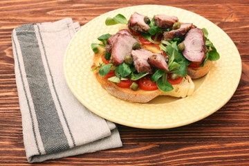 Open sandwich with pork greens and capers