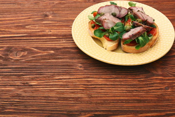 Obraz na płótnie Canvas Open sandwich with pork greens and capers