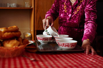 Kazakh grandma pours tea