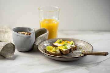 Sandwich with apricot jam and cottage cheese on a white plate, end with copy space