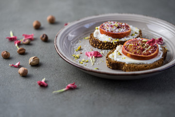 Sandwich with red orange and cottage cheese on a white plate, a close up with copy space