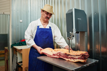 Kazakh butcher at work, cuts meat