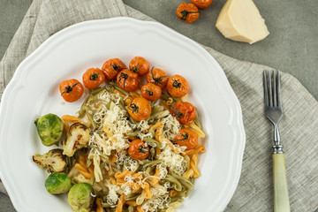 noodles with tomatoes and a Brussels sprout. tasty pasta-Italian meat sauce pasta on the table