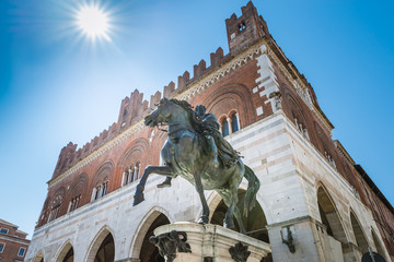 Piacenza, medieval town, Italy. Piazza Cavalli (Square horses), equestrian monument at Ranuccio I Farnese (XVII century), in the background the palazzo Gotico (Gothic palace) in the city center   - obrazy, fototapety, plakaty