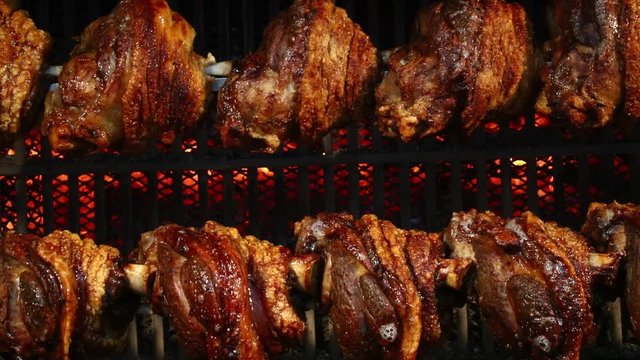 Pork knuckles slowly cooked at rotation grill