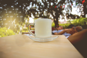Warm milk in a cup with a cozy atmosphere on holiday