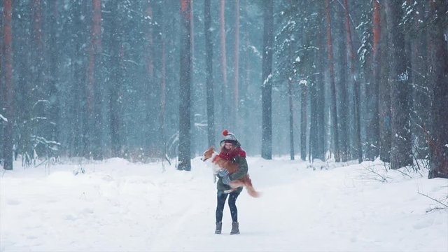 Young happy woman having fun with her dog