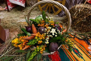 Basket with organic vegetables on the green grass and flowers. Outdoors. freshly harvested vegetables. raw vegetables in wicker basket.basket with Vegetables and Flowers