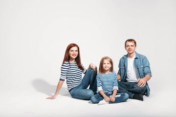 Happy family portrait sitting on white background isolated