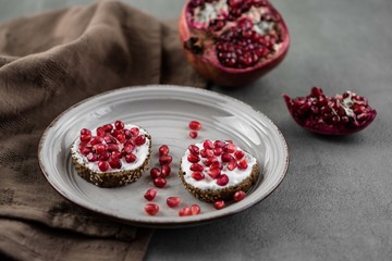 bread with cream cheese and pomegranate seeds.bread with cream cheese and pomegranate seeds.