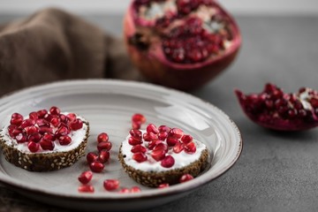 bread with cream cheese and pomegranate seeds.
