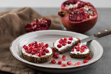 bread with cream cheese and pomegranate seeds.