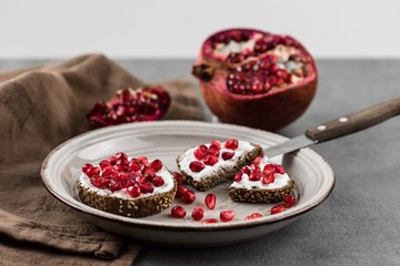 bread with cream cheese and pomegranate seeds.