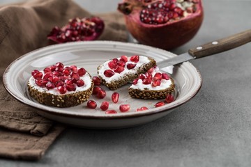bread with cream cheese and pomegranate seeds.