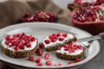 bread with cream cheese and pomegranate seeds.bread with cream cheese and pomegranate seeds.