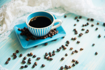 Coffee cup and coffee beans on table