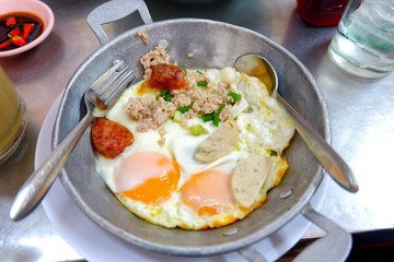 Fried egg pan (Indochina omelet breakfast) topping with pork, sweet sausage, ham, and pepper