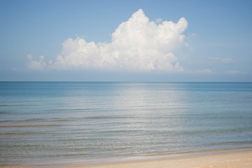 Blue ocean with big clouds on blue sky.