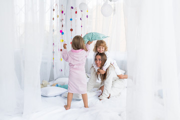Fototapeta na wymiar Woman and children on bed