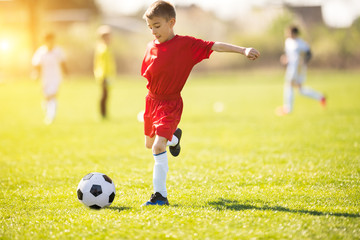 Obraz premium Kids soccer football - children players match on soccer field