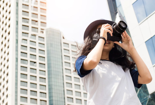 Asian Girl Take Photo In City