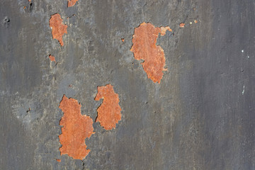 Dark grey cracked painting on metal surface