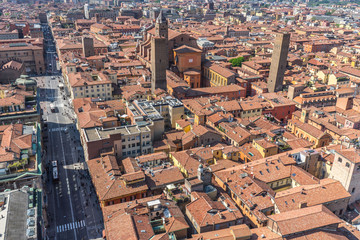Obraz premium Aerial panorma of rooftops of Bologna and Rizzoli Street from Asinelli tower, Italy