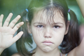 Asian girl is sad at the window 