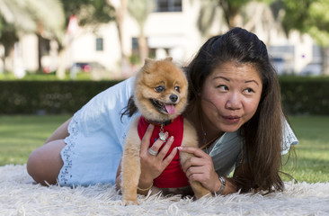 pomeranian and a young chinese lady