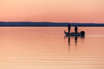 Two people fishing from small boat at sunset © Kilman Foto