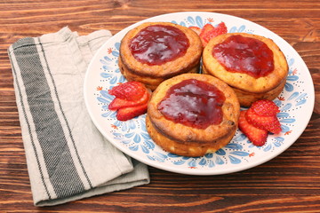 Cottage cheese patties with strawberry jam.