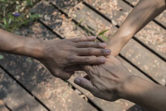 Hands of of diverse group of friends