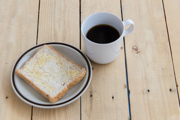 Bread and hot coffee on wood table