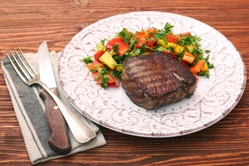 Grilled beefsteaks and vegetables