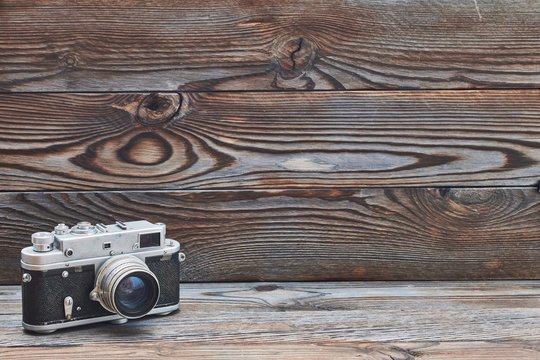 Vintage old retro rangefinder camera on wooden background
