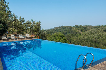 Swimming pool on top of a hill station with mountain in the background, tamilnadu, India, April 29 2017