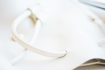 White leather and details of seams close-up. Things made of leather, texture and details of the product. 