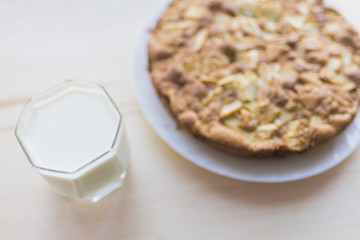 A whole apple pie and a glass of milk