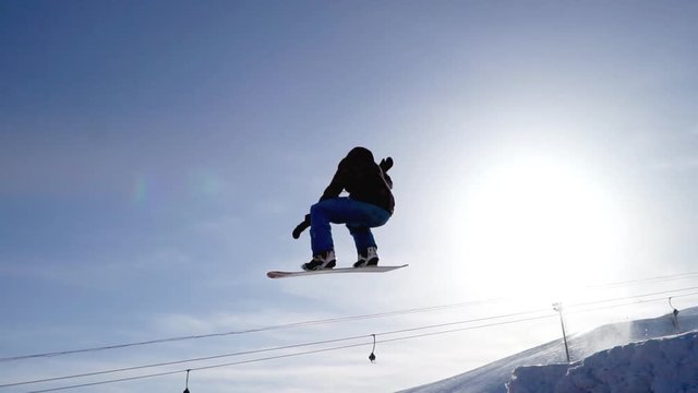 Snowboarding jumping on a kicker