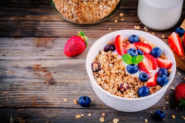 Healthy breakfast: bowl of granola with yogurt and berries
