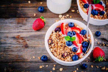 Healthy breakfast: bowl of granola with yogurt and berries