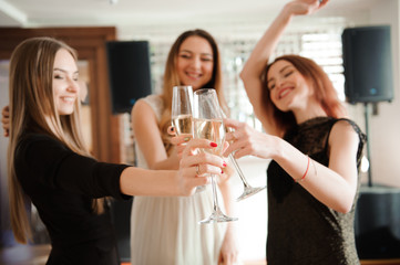Group people with champagne dancing at the party.