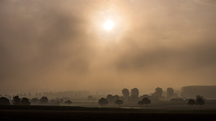 sunrise sunset with fog over the hills monotone