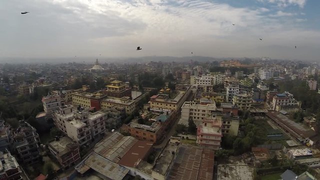aerial view of kathmandu captured with moving camera from a drone. Many birds are flying around