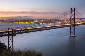 Sunset over the '25 of April' Bridge in Lisbon, Portugal.